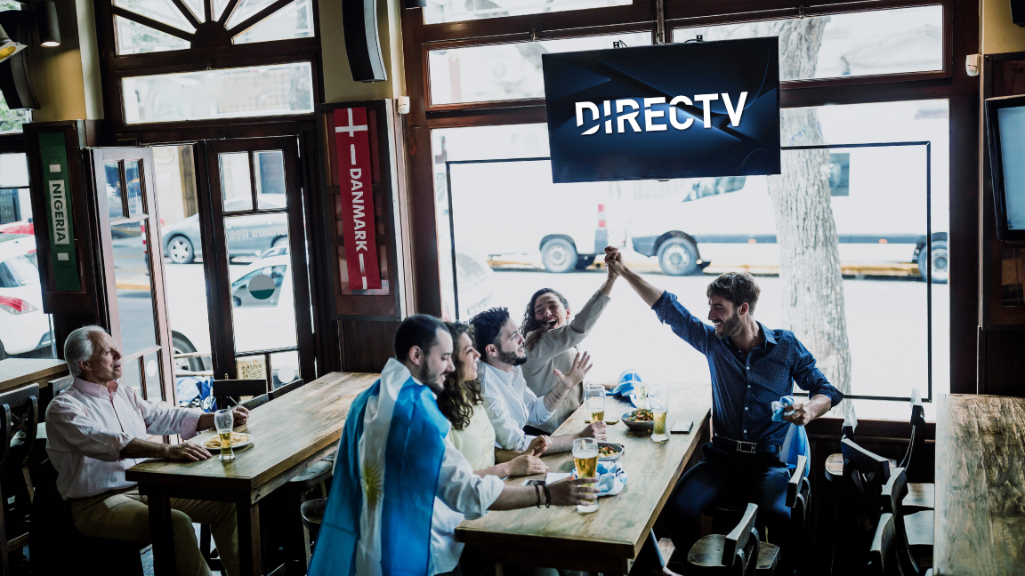 Friends at a bar with TV above them showing DIRECTV